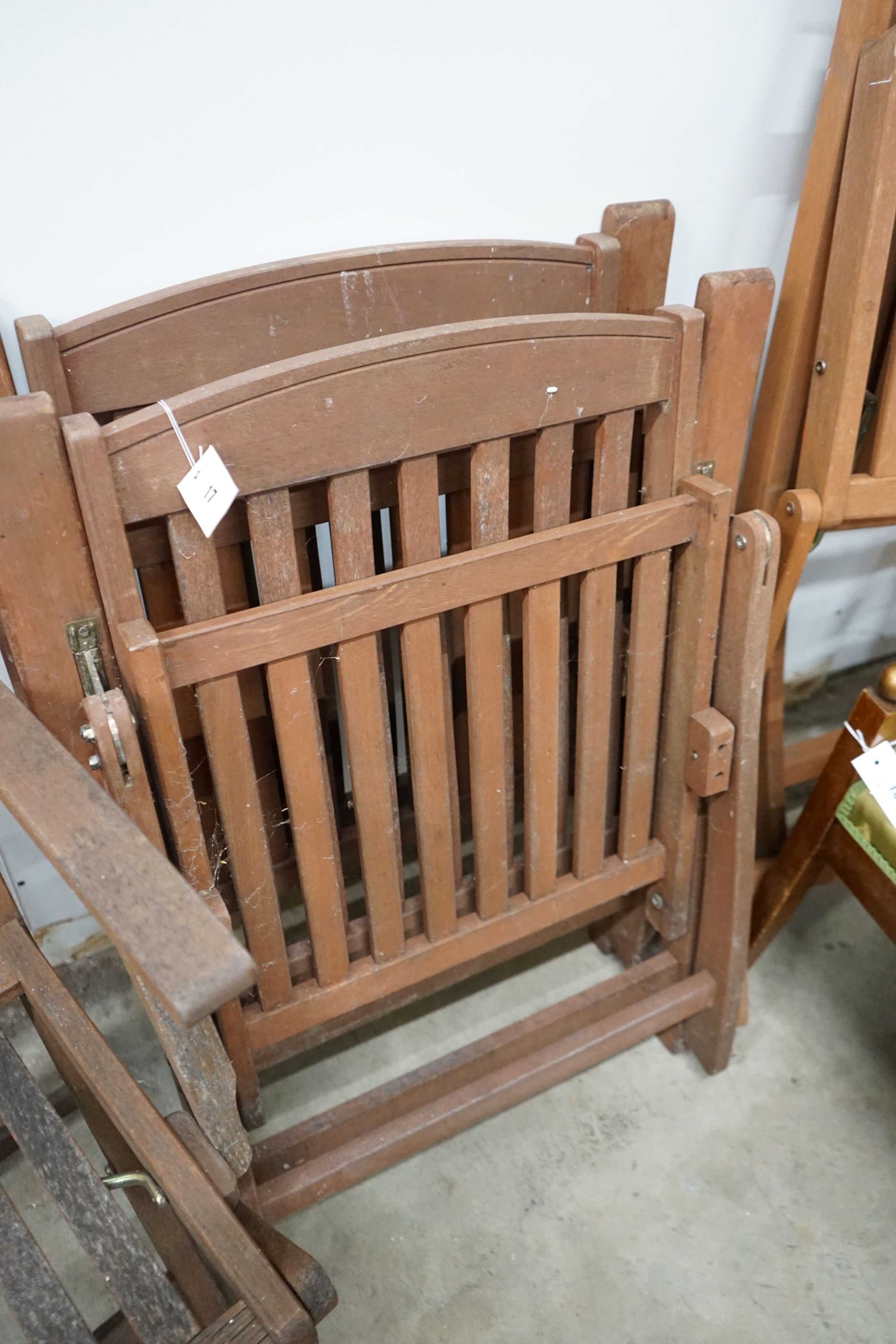 Five assorted teak folding garden chairs